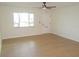Bright and spacious living room features wood-look floors and natural light at 4517 100Th N Ave, Pinellas Park, FL 33782