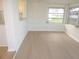 Bright sunroom featuring a serving counter and light wood colored vinyl flooring at 4517 100Th N Ave, Pinellas Park, FL 33782