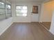 Bright sunroom featuring a large window and light wood colored vinyl flooring at 4517 100Th N Ave, Pinellas Park, FL 33782