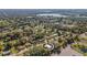 An aerial photo of a home with a nearby lake in a scenic, green neighborhood at 4814 Edmund Ct, Dover, FL 33527
