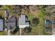 An aerial view shows the home on a treed lot with a large, fenced backyard at 4814 Edmund Ct, Dover, FL 33527