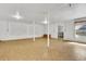 Unfinished basement area featuring concrete support beams, a window, and vinyl flooring at 4814 Edmund Ct, Dover, FL 33527