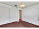 Spacious bedroom with a closet and a second door, complemented by neutral walls and carpet flooring at 4814 Edmund Ct, Dover, FL 33527