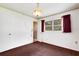 Bright bedroom featuring a closet and an open door to another room, complemented by neutral walls and carpet flooring at 4814 Edmund Ct, Dover, FL 33527