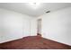 Spacious bedroom featuring a closet and an open door to another room, complemented by neutral walls and carpet flooring at 4814 Edmund Ct, Dover, FL 33527