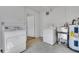 Functional laundry room with washer, dryer, water heater and ample space for storage at 4814 Edmund Ct, Dover, FL 33527