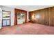 Inviting living room with wood paneling, curtains, and carpeted floors for comfortable living at 4814 Edmund Ct, Dover, FL 33527