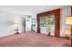 Bright living room filled with natural light showcasing ample space and warm carpet at 4814 Edmund Ct, Dover, FL 33527