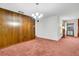 Spacious living room featuring wood paneling and ample natural light, perfect for relaxing at 4814 Edmund Ct, Dover, FL 33527