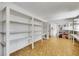 Spacious storage area with white shelves, vinyl flooring, and a doorway leading to another room at 4814 Edmund Ct, Dover, FL 33527