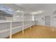 Bright storage room features many white shelves, window, and easy-to-clean vinyl flooring at 4814 Edmund Ct, Dover, FL 33527