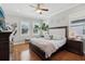 Well-lit bedroom featuring hardwood floors, windows with shutters and a ceiling fan at 518 33Rd N Ave, St Petersburg, FL 33704