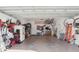 Garage with a plethora of items, including bikes, ladders, fridge and tools at 518 33Rd N Ave, St Petersburg, FL 33704