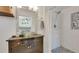 Bright bathroom showcasing a shower with tiled walls and a mosaic accent, plus a rustic vanity with a vessel sink at 5205 13Th S Ave, Gulfport, FL 33707