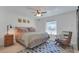 Serene bedroom with neutral tones, a ceiling fan, and a cozy rocking chair at 5205 13Th S Ave, Gulfport, FL 33707