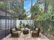 Serene backyard featuring outdoor seating, lush greenery, and a relaxed, tropical vibe at 525 Lamara Ne Way, St Petersburg, FL 33704