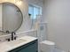 Elegant bathroom showcasing marble-look tiling, modern fixtures, and a sleek toilet design at 525 Lamara Ne Way, St Petersburg, FL 33704
