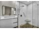 Bathroom boasts a floating vanity, modern shower with built-in seat, and patterned shower floor at 525 Lamara Ne Way, St Petersburg, FL 33704