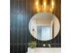 Stunning bathroom features a decorative round mirror, custom tile and modern lighting at 525 Lamara Ne Way, St Petersburg, FL 33704