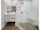 Stylish bathroom with a floating vanity, decorative mirror, and tiled shower with built-in seat at 525 Lamara Ne Way, St Petersburg, FL 33704
