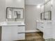 Bright bathroom showcasing dual floating vanities and a glass-enclosed shower with stylish tile work at 525 Lamara Ne Way, St Petersburg, FL 33704