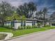Beautiful single-story home with a white exterior, manicured lawn, and lush landscaping at 525 Lamara Ne Way, St Petersburg, FL 33704