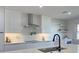 Modern kitchen with stainless steel appliances, a kitchen island, and sleek white cabinetry at 525 Lamara Ne Way, St Petersburg, FL 33704