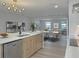 Open-concept kitchen featuring an island, stainless steel appliances, and dining area at 525 Lamara Ne Way, St Petersburg, FL 33704