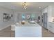 Bright kitchen featuring a center island with seating, stainless appliances, and open to the living room at 525 Lamara Ne Way, St Petersburg, FL 33704