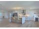 Bright kitchen with a large island, stainless appliances, modern cabinetry, and easy access to the dining space at 525 Lamara Ne Way, St Petersburg, FL 33704