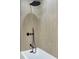 Sleek shower featuring modern fixtures, a rain shower head, and light wood-look tiling at 525 Lamara Ne Way, St Petersburg, FL 33704