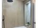 Modern shower with neutral-toned, vertically stacked tiles and a niche with marble accent at 525 Lamara Ne Way, St Petersburg, FL 33704