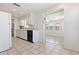 Spacious kitchen featuring white cabinetry, tile flooring, and a view into the dining area at 5313 Mosaic Dr, Holiday, FL 34690