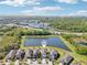 Aerial view showcasing the property's location near a pond, surrounded by lush greenery and residential homes at 5955 Sweet Birch Dr, Riverview, FL 33578