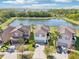Aerial view of homes with well-manicured lawns, and a pond, located in a picturesque community at 5955 Sweet Birch Dr, Riverview, FL 33578