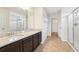 Bathroom with granite countertops, dark cabinets, and a shower at 5955 Sweet Birch Dr, Riverview, FL 33578