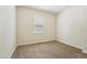 A carpeted bedroom with a window that filters in soft, natural light at 5955 Sweet Birch Dr, Riverview, FL 33578