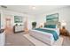 Bright main bedroom featuring modern decor and furnishings, connecting to en suite bathroom at 5955 Sweet Birch Dr, Riverview, FL 33578