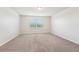 Spacious carpeted bedroom with windows providing a bright, inviting atmosphere at 5955 Sweet Birch Dr, Riverview, FL 33578