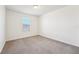 A neutral bedroom with a window allowing natural light to illuminate the space at 5955 Sweet Birch Dr, Riverview, FL 33578