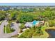 Areal view of a large community pool and amenity center surrounded by lush landscaping and walking trails at 5955 Sweet Birch Dr, Riverview, FL 33578