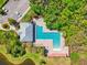 Aerial view of a large, modern community pool area surrounded by trees and featuring a lounge and seating at 5955 Sweet Birch Dr, Riverview, FL 33578