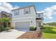 Well-maintained two-story home with neutral siding, an attached garage, and manicured landscaping at 5955 Sweet Birch Dr, Riverview, FL 33578