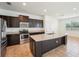 Beautiful kitchen with stainless steel appliances, dark wood cabinetry, and granite countertops at 5955 Sweet Birch Dr, Riverview, FL 33578