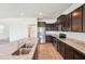 Open kitchen with stainless steel appliances, granite countertops, tile floors, and ample counter space at 5955 Sweet Birch Dr, Riverview, FL 33578