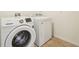 Bright laundry room featuring modern washer and dryer appliances at 5955 Sweet Birch Dr, Riverview, FL 33578