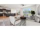 Bright living area with large windows and views of the water; modern kitchen with bar seating at 5955 Sweet Birch Dr, Riverview, FL 33578