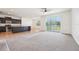 Inviting open-concept living space featuring a kitchen island, and a seamless flow to the dining and living areas at 5955 Sweet Birch Dr, Riverview, FL 33578