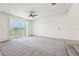 Bright, spacious living room featuring a sliding glass door that leads to a serene outdoor view at 5955 Sweet Birch Dr, Riverview, FL 33578