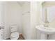 Powder room featuring a toilet, sink, mirror, and neutral wall color at 5955 Sweet Birch Dr, Riverview, FL 33578